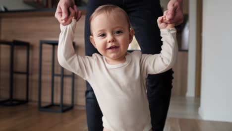 first steps of little girl at home interior.