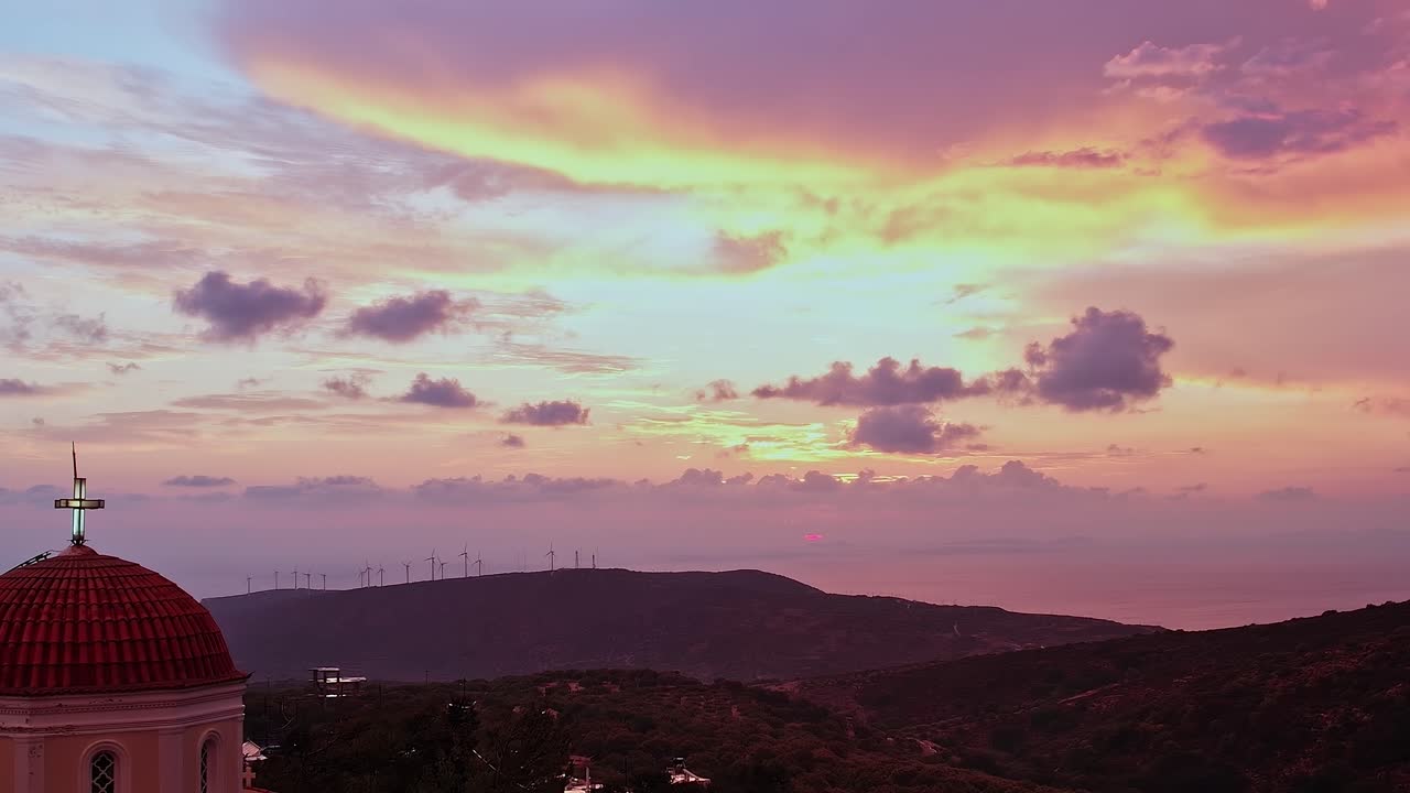 Aerial View of a Church and Wind Turbines at Sunset
