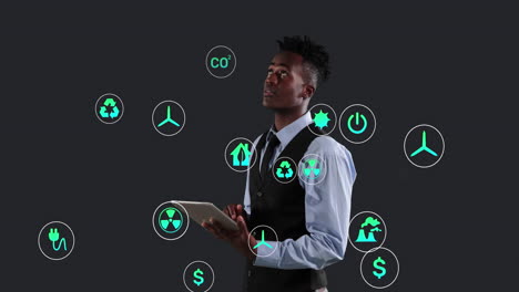 animación de múltiples iconos digitales sobre un empresario afroamericano que usa una tableta digital