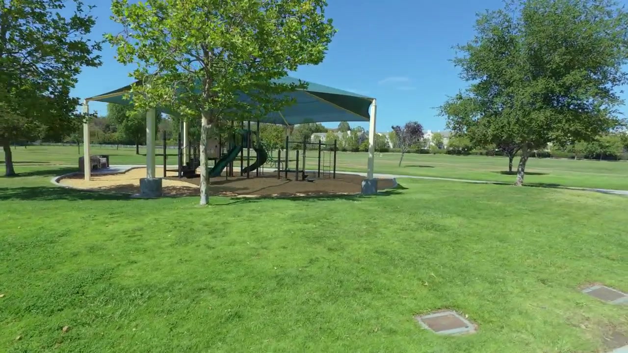 A steady cam shot of a playground in a public park