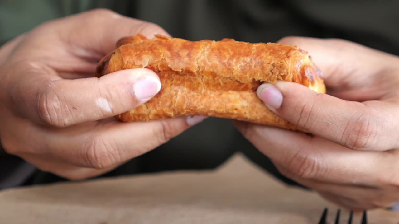 Person eating a pastry