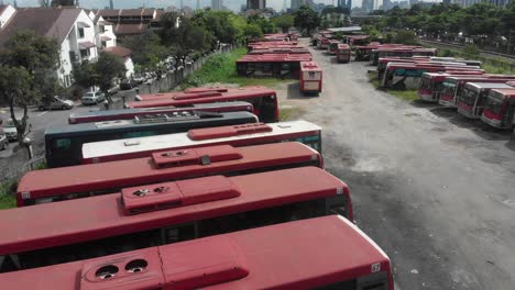 Broken,-Destroyed,-Abandoned-buses-at-Kuala-lumpur,-aerial