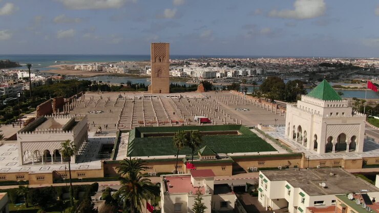 Mozzafiato panorama aereo in HD dell'iconica Torre di Hassan e del Mausoleo di V a Rabat, Marocco. Questa ampia inquadratura cattura la grandezza architettonica dello storico minareto e del pilastro di marmo
