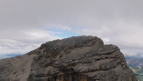 Aerial-flyover-fog-covered-peak-of-mountain-in-italian-Dolomites-during-cloudy-day