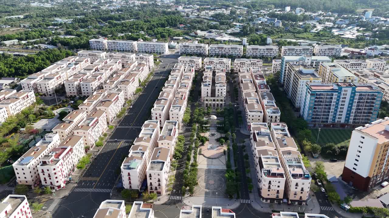Aerial video captures both the progress and completion of a well-planned smart city development. this recently developed island city. roads with less traffic, suggesting efficient urban planning