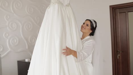 Beautiful-and-lovely-bride-in-night-gown-and-veil-running-to-wedding-dress