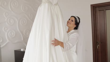 beautiful and lovely bride in night gown and veil running to wedding dress