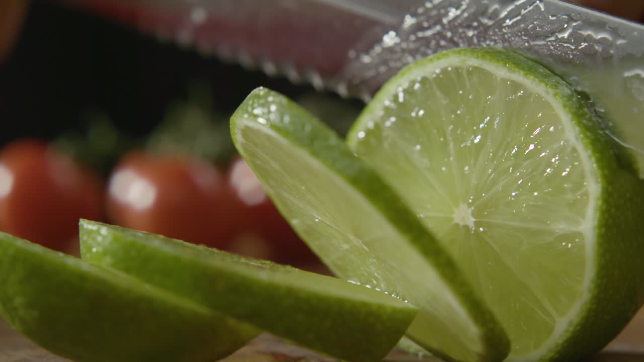 Close-up of fresh green lime sliced by steel knife. Focus on foreground