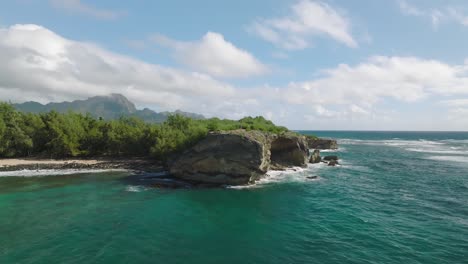 Fast-moving-Aerial-Shot-Orbiting-around-the-Cliff-at-Shipwreck-Beach,-Hawaii