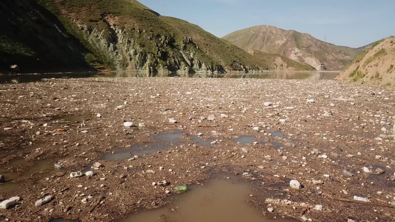 Drone footage captures plastic pollution along the coastline with industrial waste and floating garbage damaging the environment and threatening industrial plastic polluted recycling waste marine life