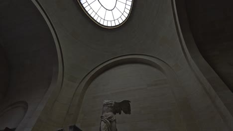 statue under a grand arched ceiling