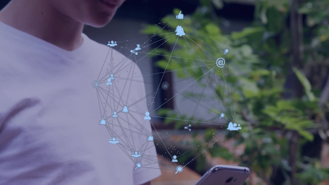 Boy holding smartphone in garden, displaying floating social media icons and data network lines