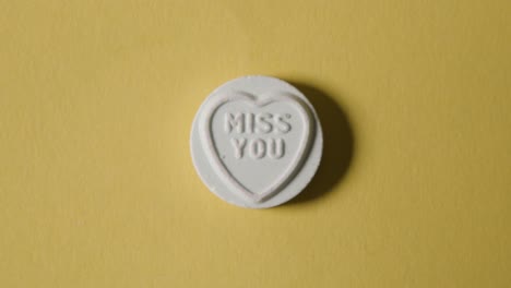 Heart-Candy-With-Miss-You-Message-On-Yellow-Background