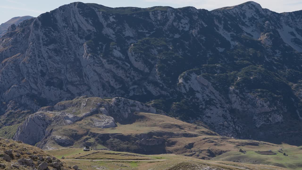 Durmitor’s majestic peaks rise above vibrant green grasslands, creating a breathtaking natural view