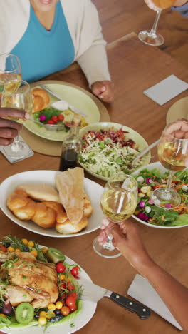 happy senior diverse people having dinner at retirement home