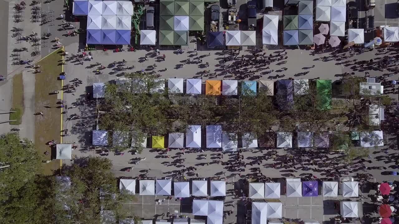 video de drones aéreos de 4k del mercado de agricultores en el parque frente al mar en st