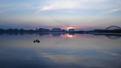 dutch ducks swimming on a lake during sunrise