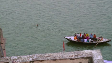 panning shot of rowing boats on the ganges