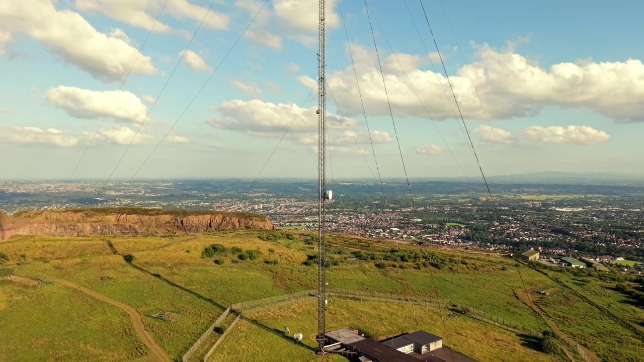 Rising 4K 60FPS aerial video of the Black Mountain Transmitting Station in West Belfast, Northern Ireland in the UK on a bright sunny day. Produced with Rec709 colour.