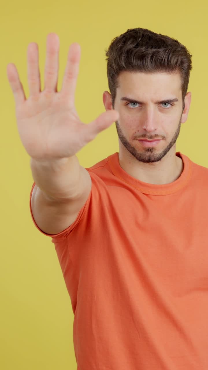 Man making a stop hand gesture