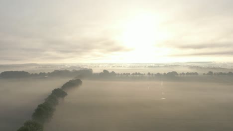 misty sunrise over rural fields