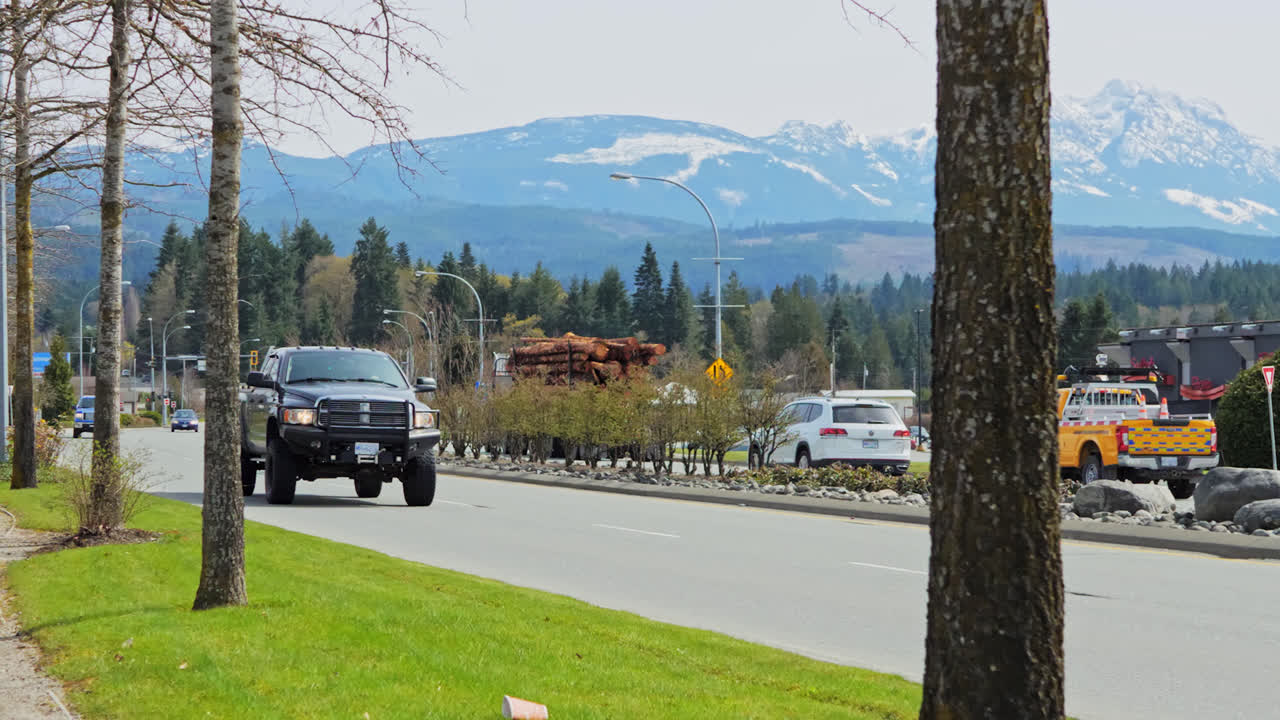 Pickup Truck Driving on a Highway with Mountains in the Background