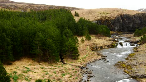 aerial view over wild river and waterfall in beautiful scenery - iceland