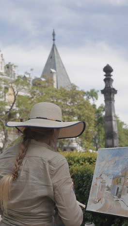 artist painting outdoors in a city