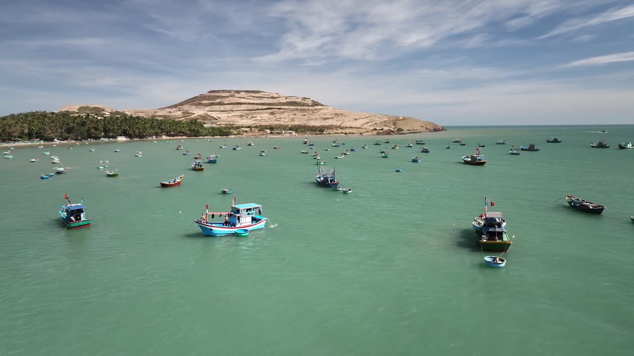 Aerial footage showcasing Bình Thuận Province's urban panorama under dramatic cloudy skies. The sprawling cityscape reveals roads and buildings in a tranquil, overcast setting