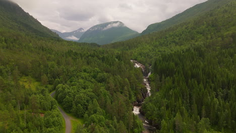 freshwater stream flowing forested rocky mountains on the west coast, norway