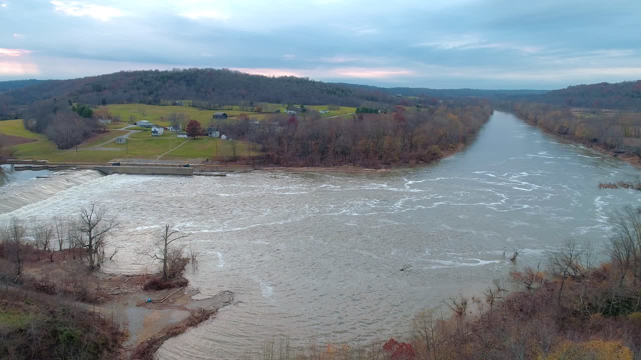 Aerial shot over the mouth of Cedar Creek entering the Kentucky river at lock and dam number 3 looking out over a farm at sunset