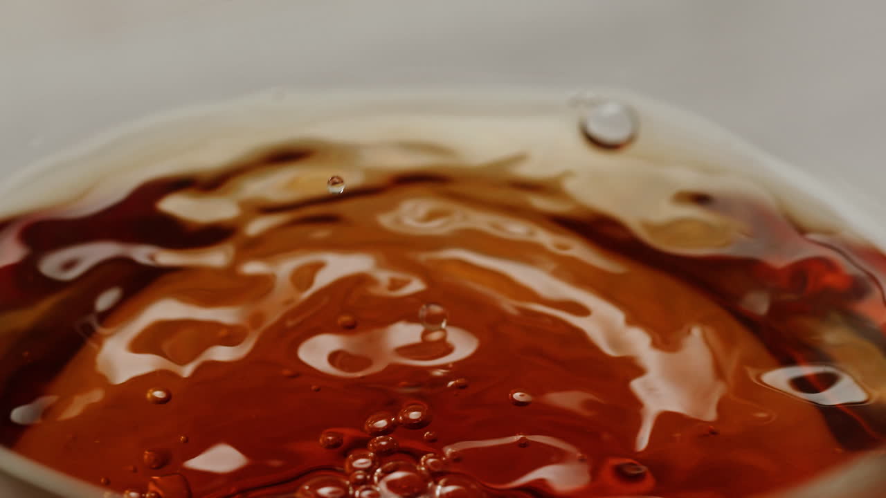 Pouring citrus tea in cup close-up. Fresh hot herbal tea with mint and oranges, healthy morning, detox drink. High quality 4k footage