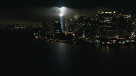 An-aerial-view-of-the-Freedom-Tower-in-New-York-City-at-night,-with-the-tribute-in-light-twin-beams-illuminated