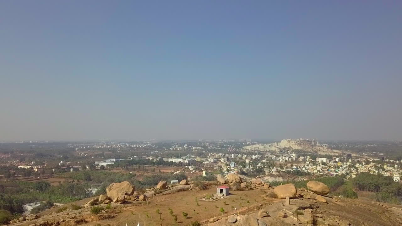 Moving aerial shot capturing Akkayamma Betta Hill beside a town in Bangalore, India. 4k. Naturescape.