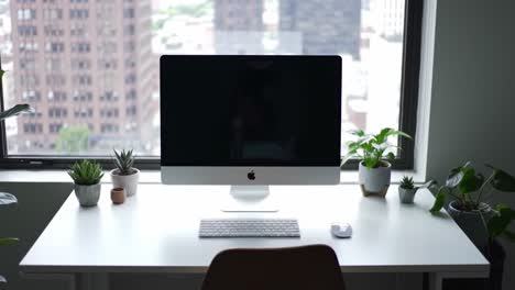 modern workspace with a sleek desktop computer surrounded by lush greenery, offering a peaceful atmosphere for productivity and creativity