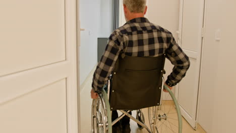 man in wheelchair in a hospital room