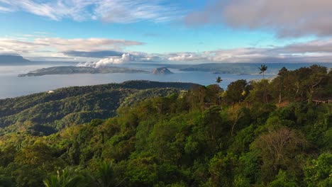 Green-lush-mountain-coastline-with-Taal-Lake-and-Volcano-at-sunset