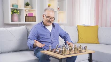 The-old-man-is-playing-chess-at-home-alone-and-bored.