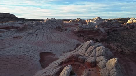 Rough-terrain-with-scenic-cliffs-and-sandy-desert-at-sundown-in-USA