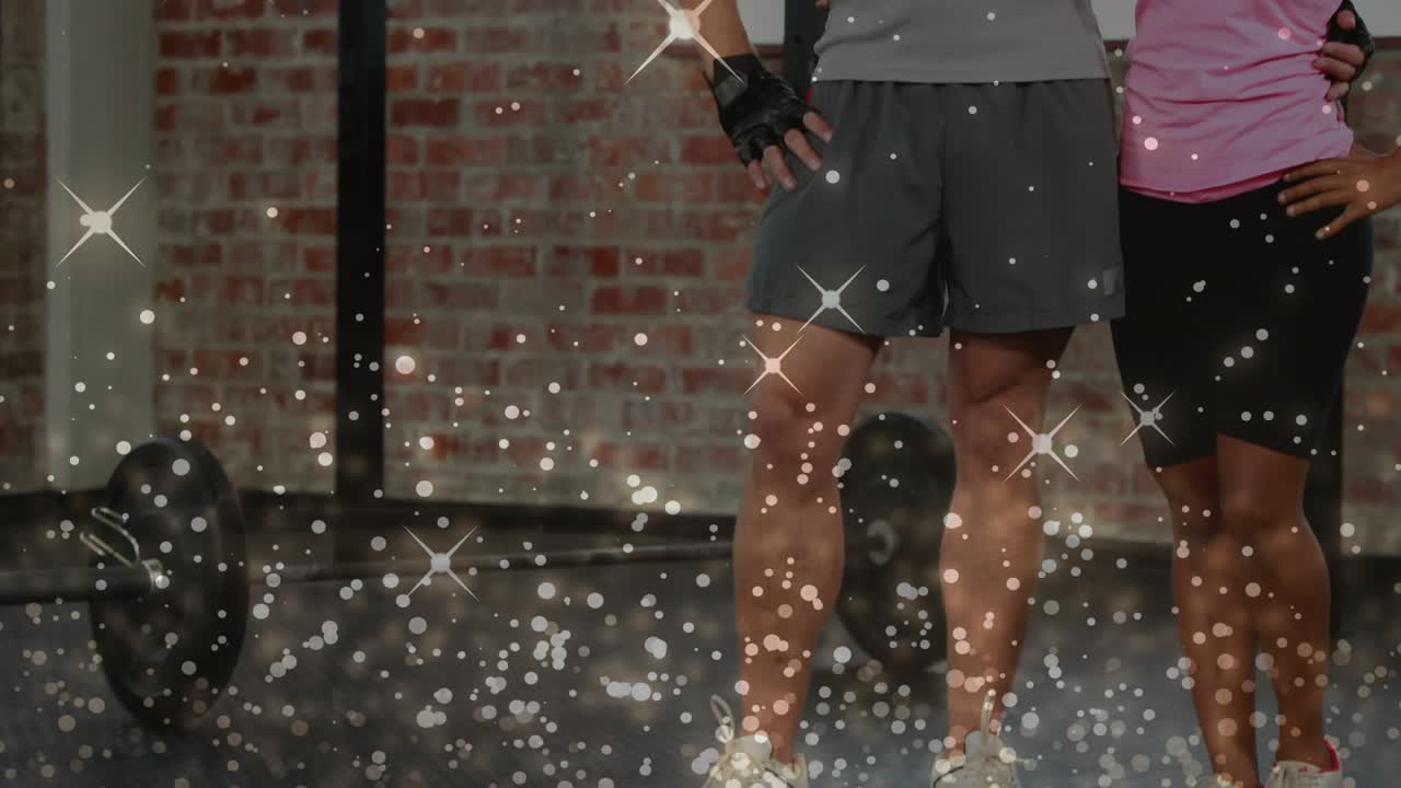 Cam pulling back, gym duo near rig celebrating and high-fiving, sparkles overlaying subjects