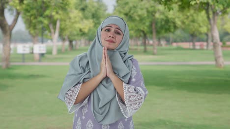 guilty muslim woman saying sorry and apologizing in park