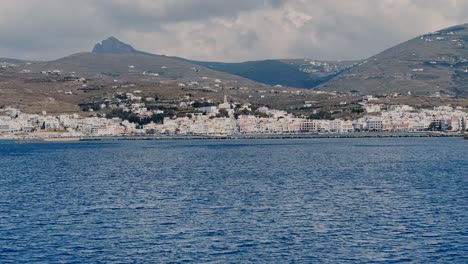 leaving the port of tinos island in greece on a cloudy day