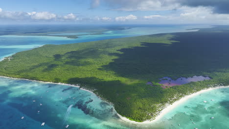 Drone-shot-slightly-pivoting-to-the-right-side-of-the-frame,-showing-the-stretch-of-a-coastline-of-a-beach-resort-in-the-Dominican-Republic