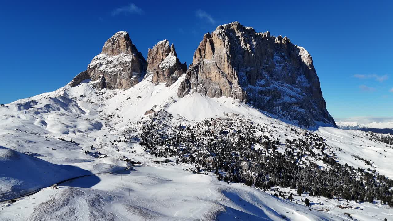 Incredible rock formation in the Italian Dolomites on a bright day during winter season (drone footage)