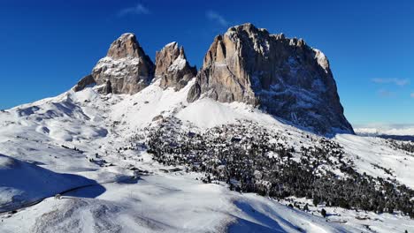 incredible rock formation in the italian dolomites on a bright day during winter season (drone footage)