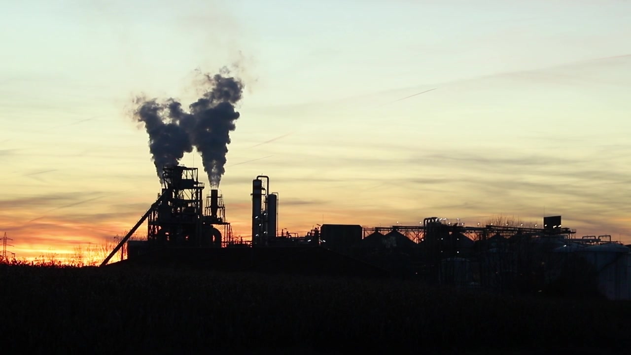 Industrial zone with a large pipe thick white smoke is poured from the factory pipe in contrast to the sun. Pollution of the environment: a pipe with smoke.