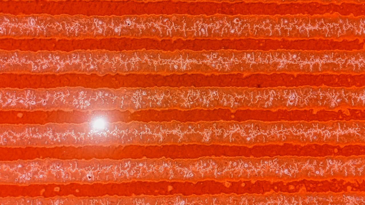 Abstract aerial view of a red textured surface with a horizontal pattern