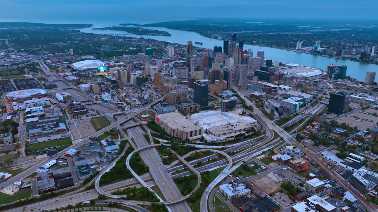 Detroit, USA, 11 August 2025: Downtown Detroit skyline and highways at sunset. Aerial view of Detroit downtown skyline with highways and Detroit River during sunset