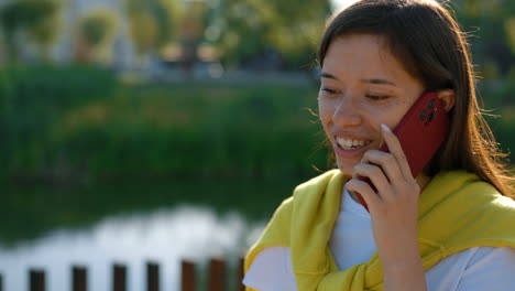 young woman talking on the phone outdoors