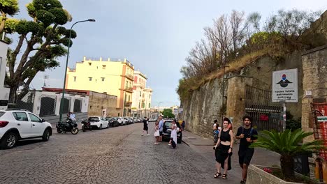 tourists walking along a cobblestone street